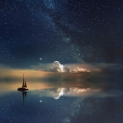 Ship on sea with night time sky