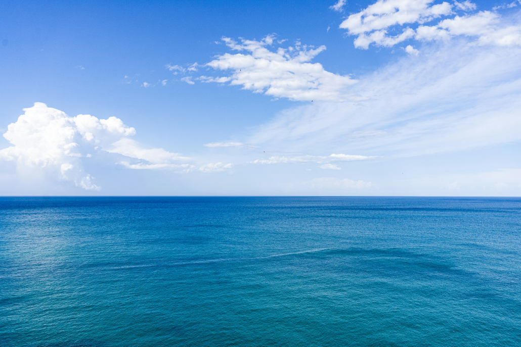 sea and clear blue sky with clouds