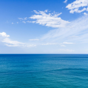 sea and clear blue sky with clouds