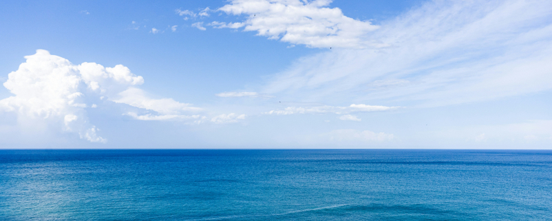sea and clear blue sky with clouds
