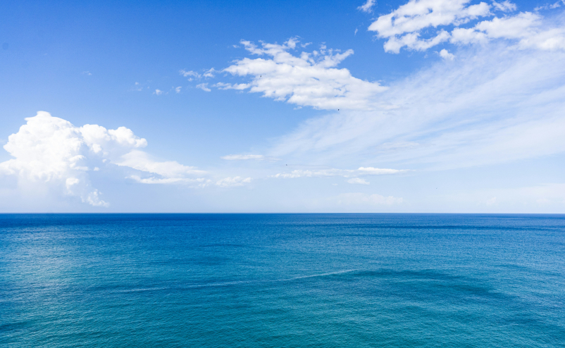 sea and clear blue sky with clouds