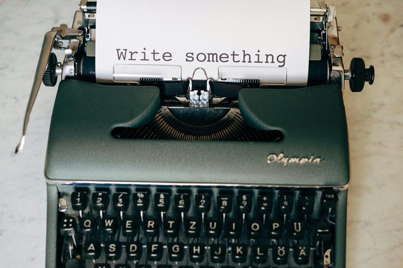 Image of typewrite with sheet of paper saying Write Something
